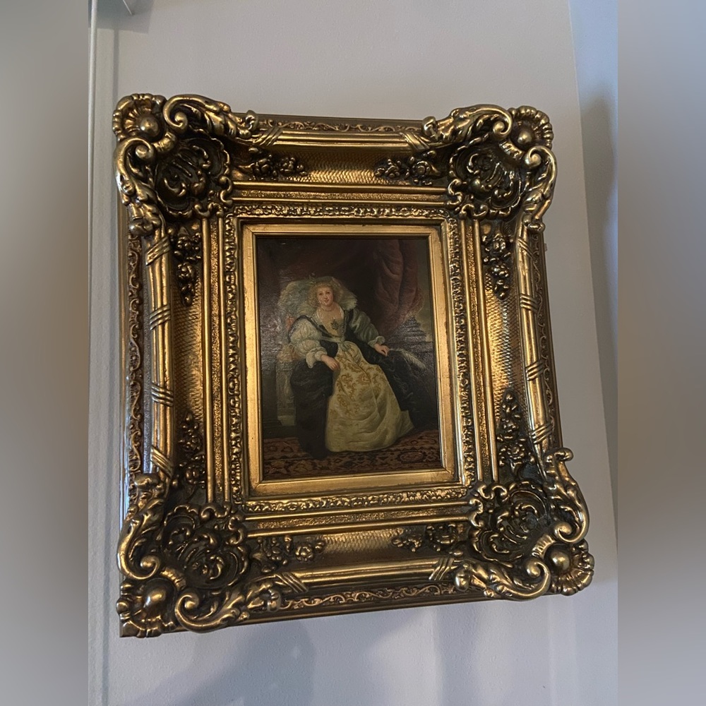 Beautiful painting of a queen sitting on a chair.